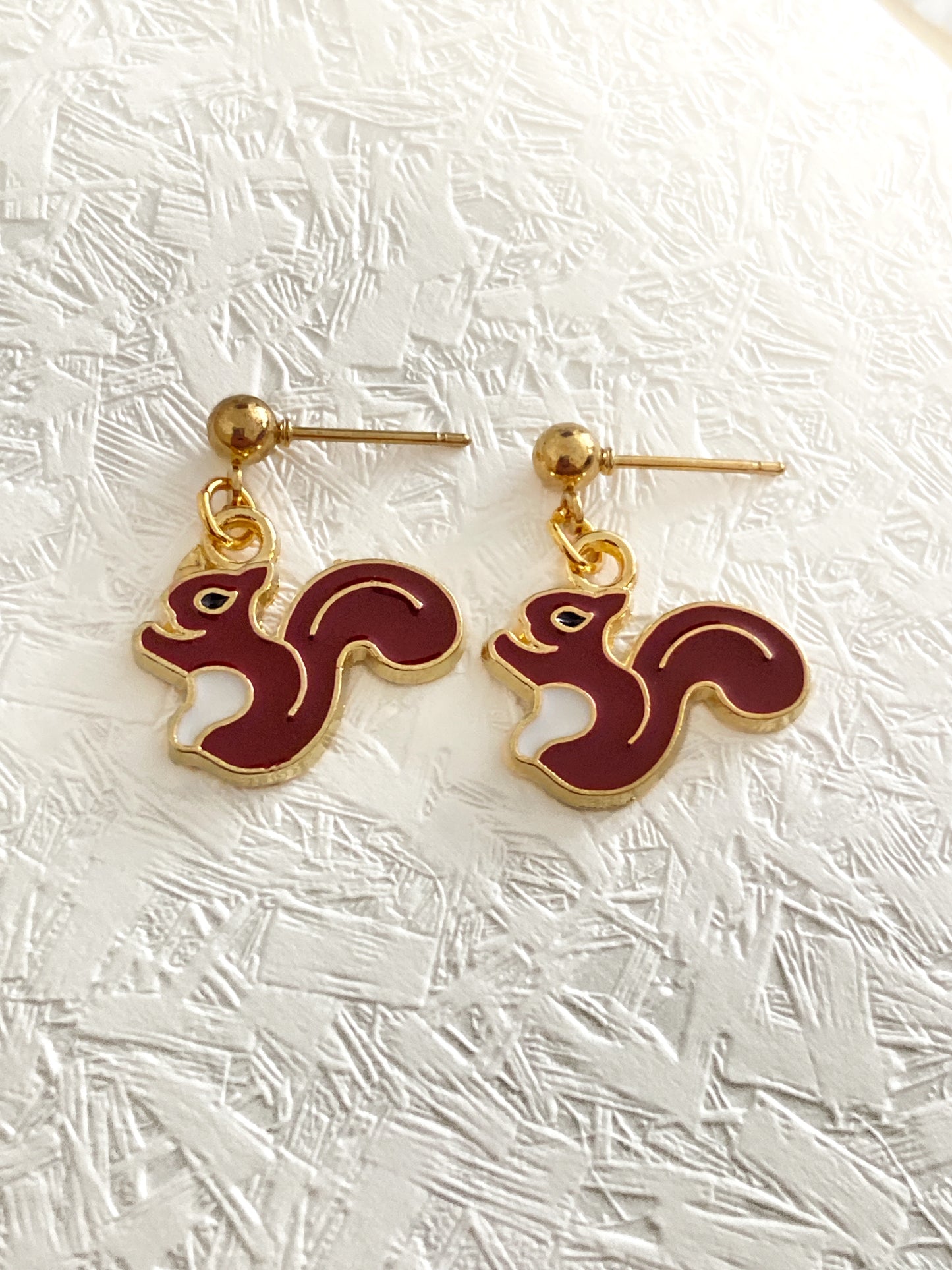 Drop earrings with meadow animal charms.