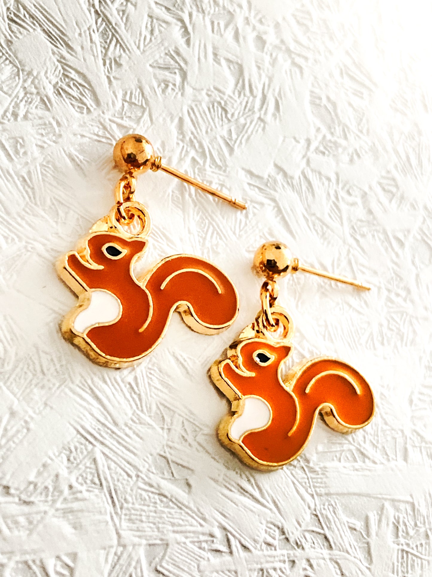 Drop earrings with meadow animal charms.